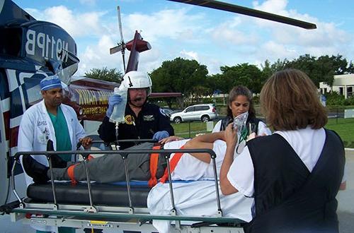 A patient on a gurney unloaded from the Trauma Hawk receiving medical care